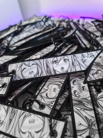 Black and white style flight tag featuring multiple ahegao faces .